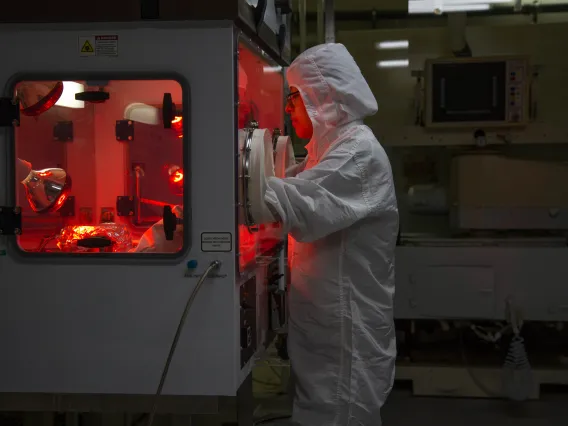 Woman in protective garments in a lab