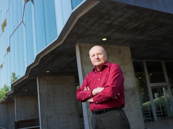 James C. Wyant poses in front of Optics building