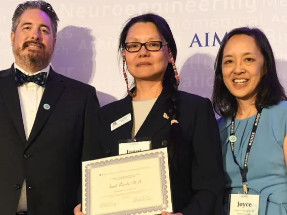 Janet Roveda, center, accepts her AIMBE fellowship certificate at the 2024 induction ceremony on March 25 in Arlington, Virginia.