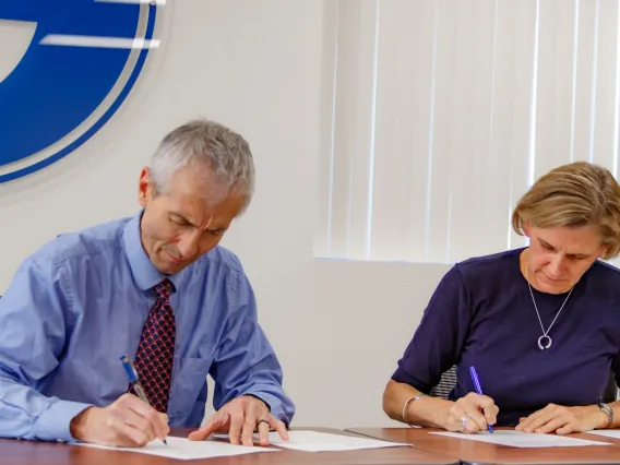 Liesl Folks and Manuel Valenzuela, SUSD Superintendent, sign the MOU