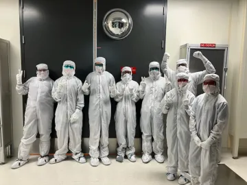 Eight CUSD camp students pose in bunny suits at Microchip Technology