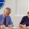 Liesl Folks and Manuel Valenzuela, SUSD Superintendent, sign the MOU