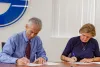 Liesl Folks and Manuel Valenzuela, SUSD Superintendent, sign the MOU